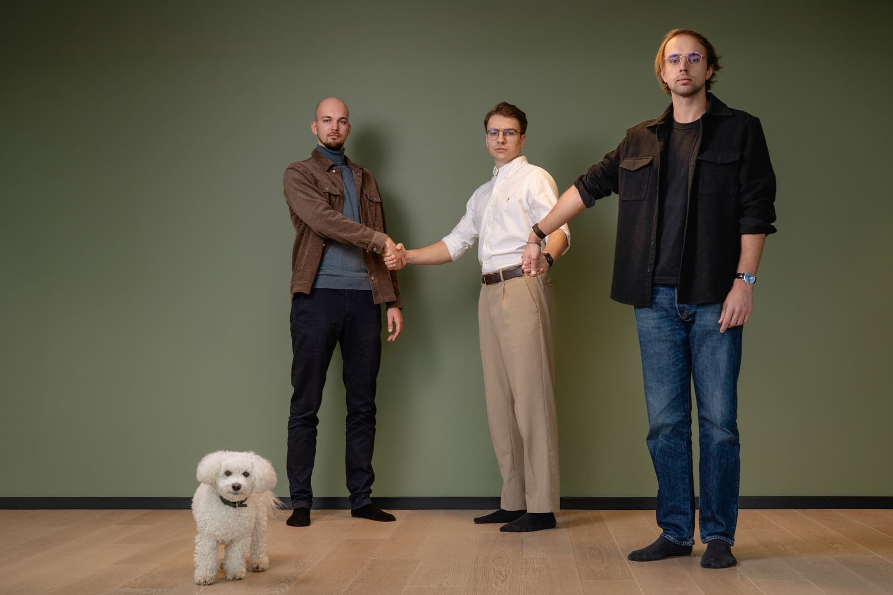 The Handhold founders holding hands in our Tallinn office
